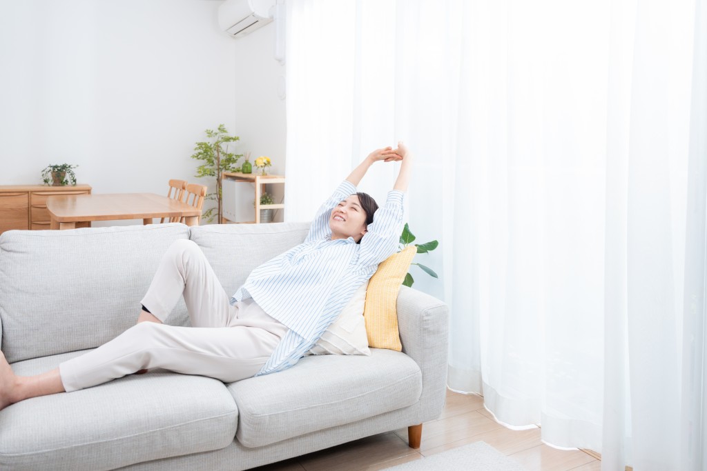 Asian,Woman,Relaxing,On,The,Sofa